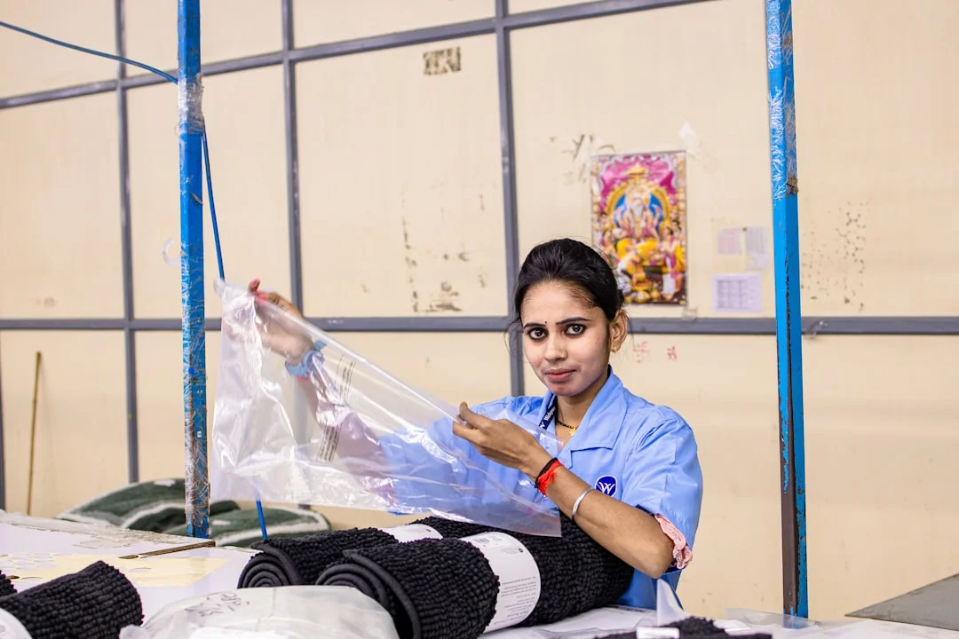 our-story A woman carefully wraps a sofa in protective material while packing boxes in a bright room.